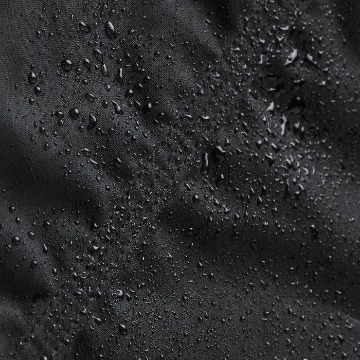 Close-up of water droplets on a black fabric surface