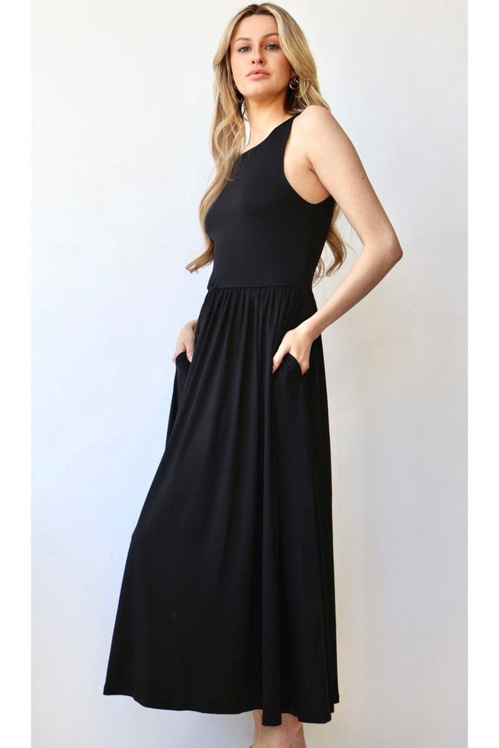Woman wearing a black high crew neck midi dress with a gathered waist and side pockets, styled elegantly from The Pink Doxie Boutique.