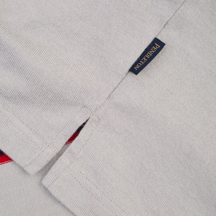 Close-up of a light gray woven fabric garment with a small navy brand tag reading PONDUTTON in gold lettering.