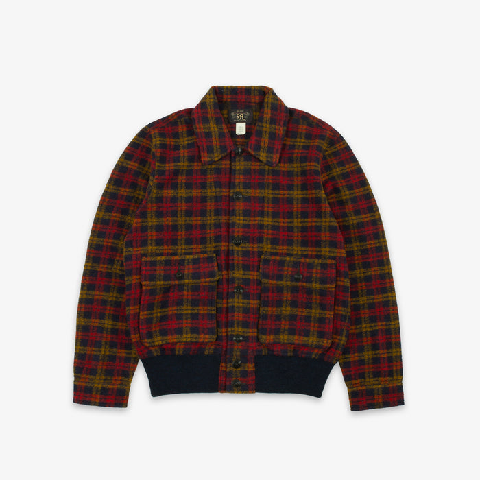 A plaid button-up jacket with a red, green, and yellow tartan pattern, featuring a dark navy ribbed collar, cuffs, and hem, displayed flat against a light gray background.