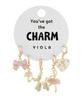 Gold charm set featuring bows, heart, poodle, and parasol